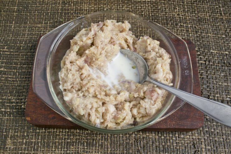 Pouring cold milk into the seasoned pork mince mixture before chilling.