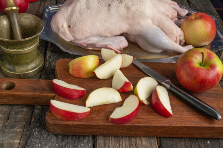 Preparing Apples for Stuffing the Duck Sliced green apples in a bowl, cored and ready for stuffing.
