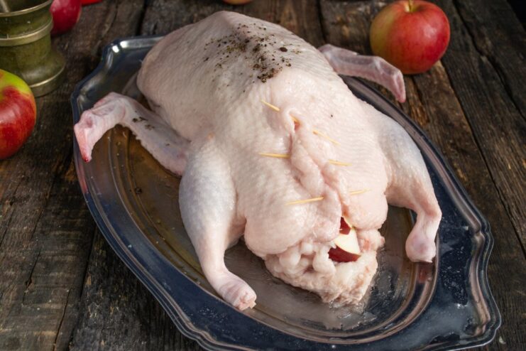 How to Secure the Stuffing in a Roast Duck Closing the duck's cavity with toothpicks to hold the apple stuffing inside.