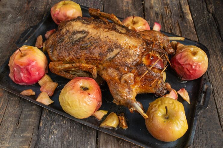 Perfectly Roasted Duck with Apples, Ready to Serve The finished golden-brown roast duck with apples on a serving platter.