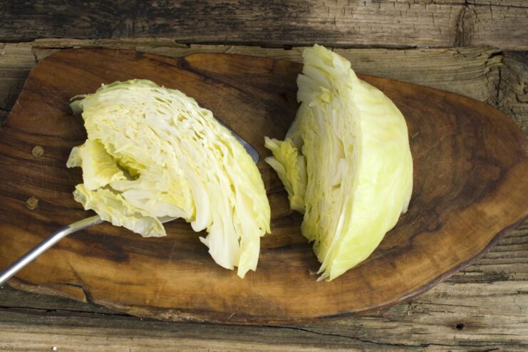 Draining the Boiled Cabbage. Let the wedges cool and drain completely in a colander. Cooked cabbage wedges resting in a white colander to drain excess water.