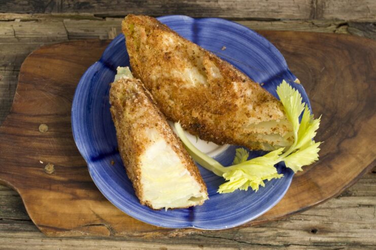 Delicious Vegetarian Cabbage Schnitzel Ready to Serve. A perfect meat-free meal. A plate of golden-brown vegetarian cabbage schnitzel, garnished with fresh herbs.