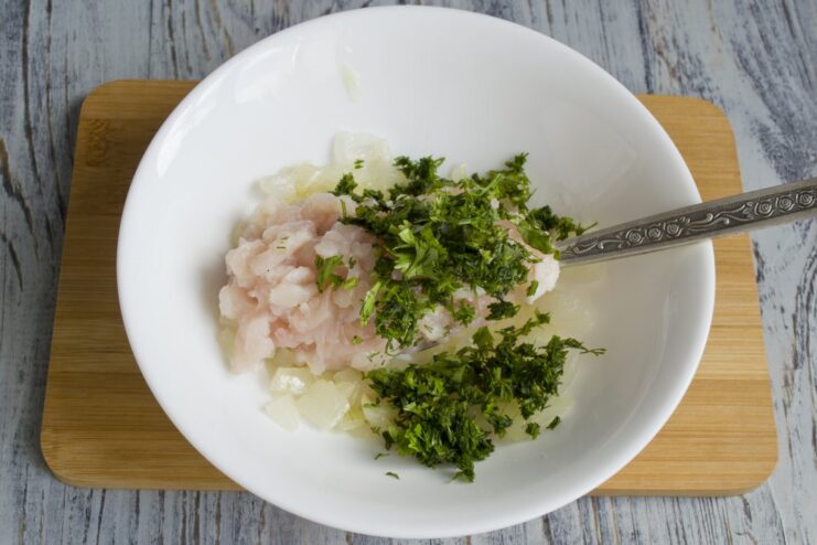 Adding Freshness: Chopping Cilantro A bunch of fresh cilantro being finely chopped on a cutting board.