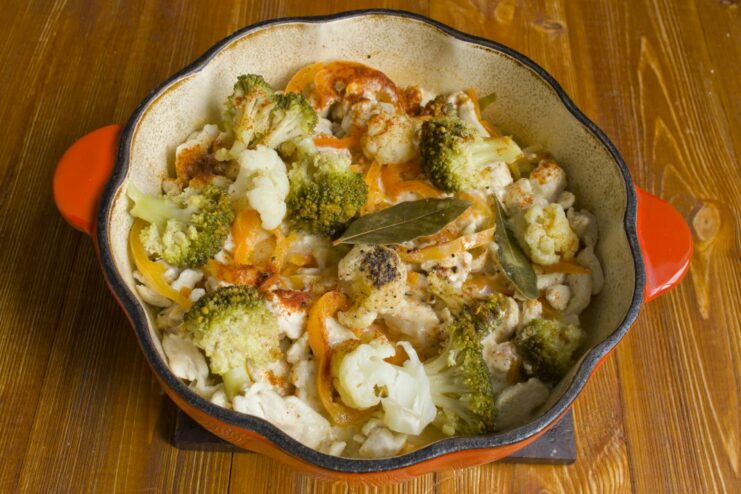 Let it Simmer: Cooking the Stew to Perfection The broccoli and chicken stew simmering in a covered pan on the stove.