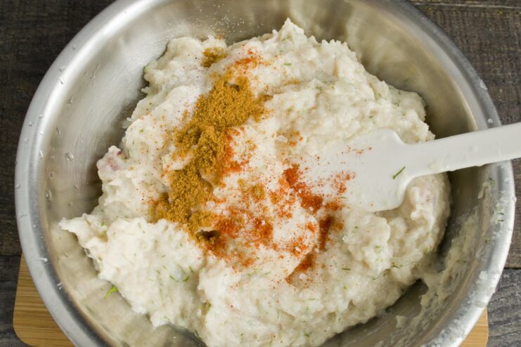 Step-by-step: Grinding chicken and bread for the patties and adding seasoning. A bowl of ground chicken mixed with soaked bread and spices, ready to be formed into patties.