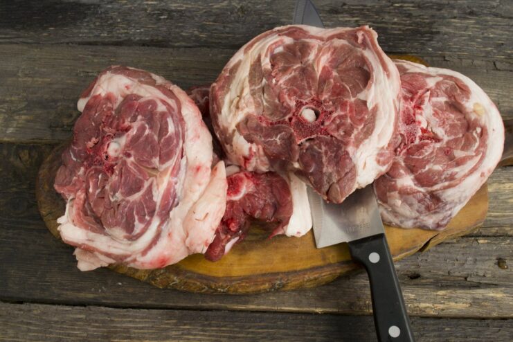 Large chunks of raw lamb meat being prepared for cooking plov.