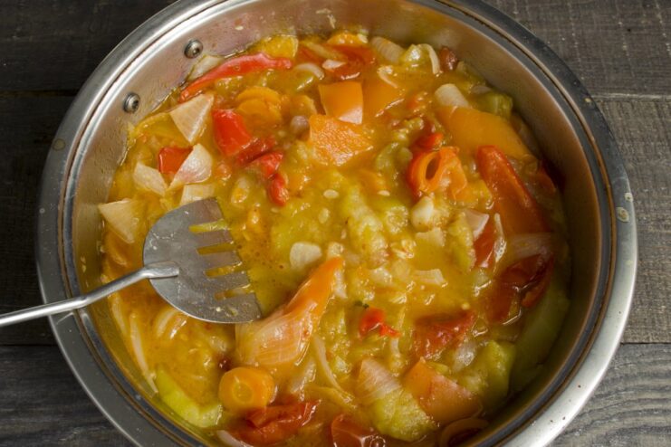 Cooked, soft vegetables simmering in a pan to make the gravy base.