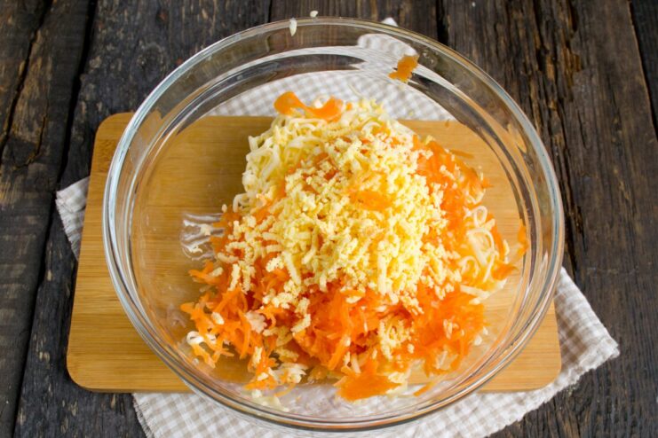 Grating boiled egg yolks for a smooth filling Boiled egg yolks being grated on a fine grater for the filling.