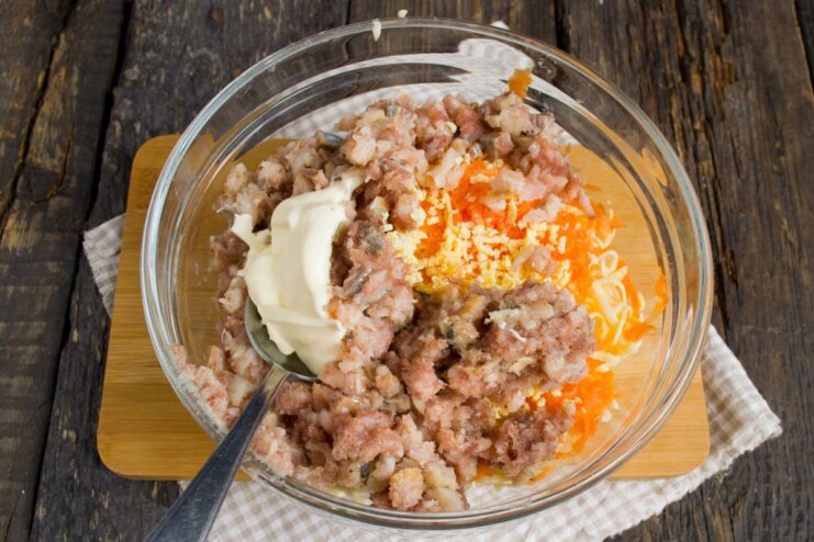 Use mayonnaise or butter for a creamy filling Mayonnaise being added to the filling mixture in a bowl.