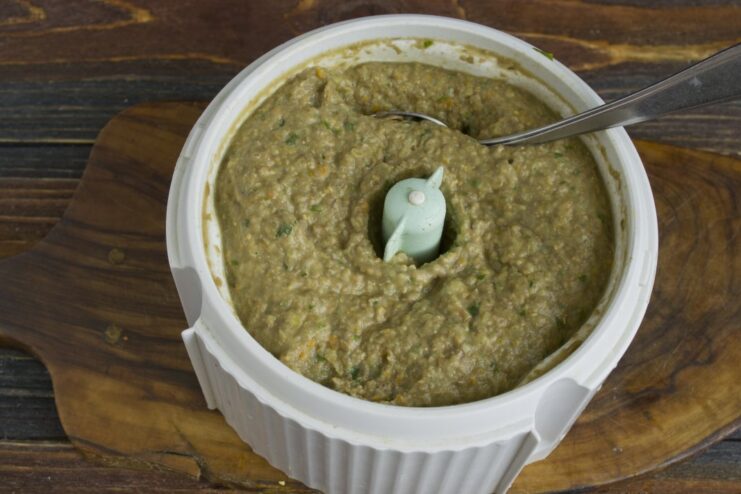 Blending the mixture to a smooth consistency for the cutlets A thick, smooth purée of lentils, mushrooms, and vegetables in a blender.