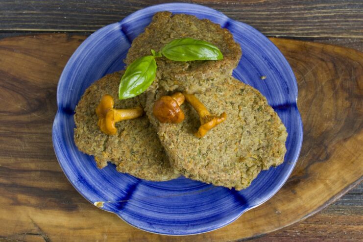The perfectly baked Lentil and Chanterelle Cutlets, ready to serve A close-up of the finished golden-brown lentil and chanterelle cutlets.