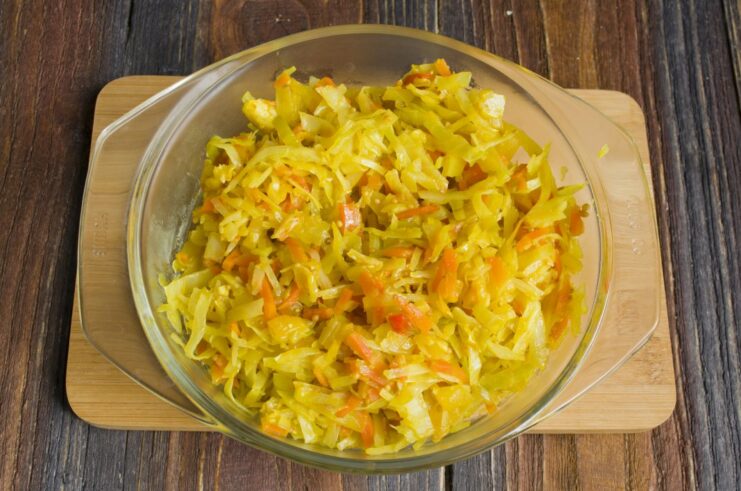 Finishing touch: reducing the liquid for a richer flavor. Stewed cabbage in a pan with the lid off, allowing liquid to evaporate.
