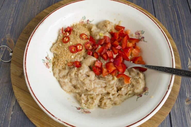 Combining Ingredients for Chicken Tefteli Mixture A bowl with minced chicken, breadcrumbs, onions, and peppers ready to be mixed.