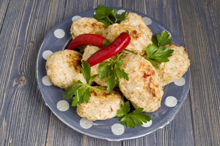 Finished Baked Chicken Meatballs Ready to Serve A close-up of freshly baked chicken meatballs on a plate, ready to eat.