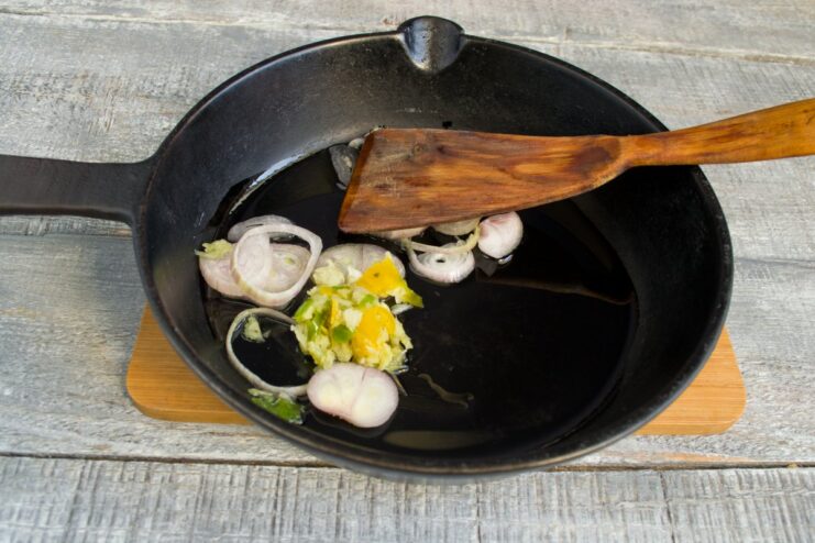 Sautéing Aromatics to Build Flavor Shallots and an aromatic paste being sautéed in a hot skillet, releasing their fragrance.
