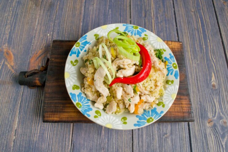 Serve Hot: Couscous with Chicken and Vegetables The final dish of couscous with chicken served in a bowl, ready to be eaten.