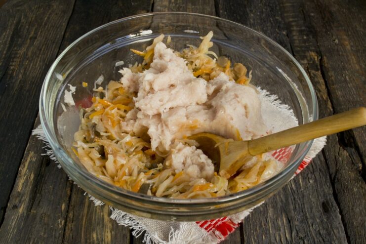 Step 2: Add ground chicken to the solyanka mixture Adding fresh ground chicken to the bowl with mushroom solyanka.