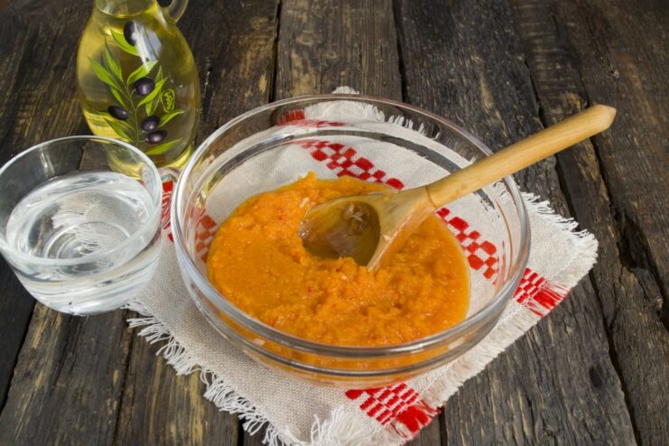 Step 5: Prepare the simple tomato sauce for baking A bowl with tomato paste, water, and oil being mixed for the sauce.