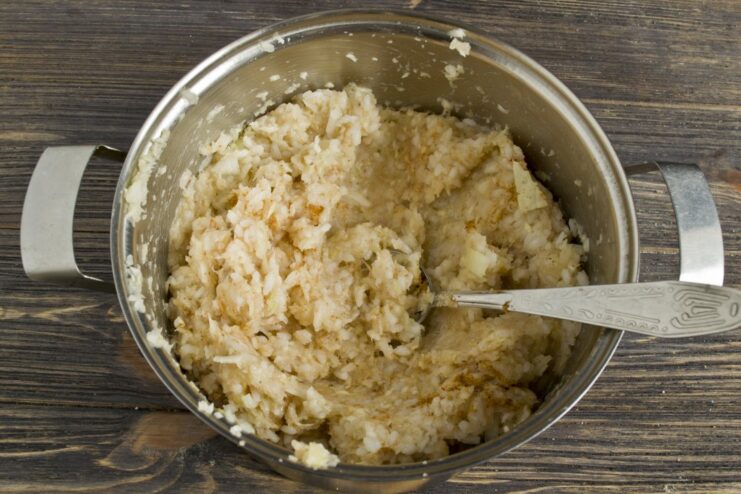 Combining All Ingredients for the Lazy Golubtsy Filling A large bowl with ground chicken, shredded cabbage, vegetables, and cooked rice being mixed together.