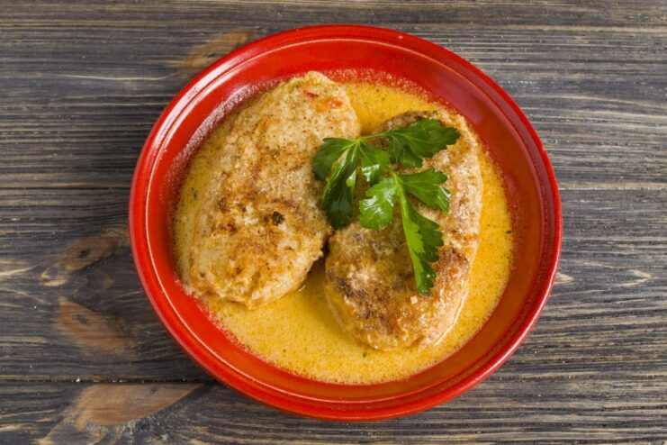 Serving the Hot and Savory Baked Lazy Cabbage Rolls A serving of baked lazy cabbage rolls in tomato sauce on a plate, garnished with fresh parsley.