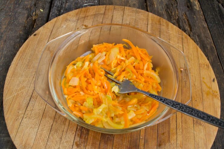 Sautéing Carrots and Onions Until Soft and Fragrant Sautéed carrots and onions cooking in a hot skillet.