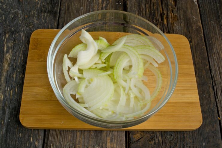 Sautéing Onions to Build a Flavorful Base for the Ragout Sliced onions being sautéed in a large pot until translucent.