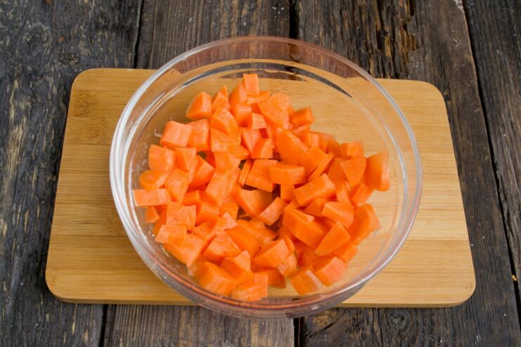 Carrots Join the Vegetable Medley Diced carrots being added to the pot with other vegetables.