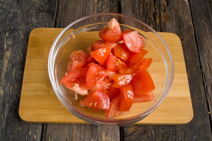 Fresh Tomatoes for a Rich and Tangy Ragout Coarsely chopped fresh tomatoes being added to the pot.