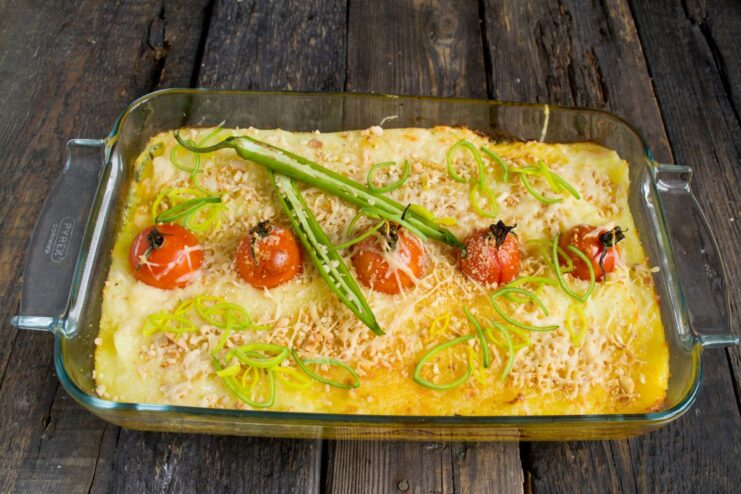 A slice of the finished chicken shepherd's pie on a plate, showing the layers and golden crust.