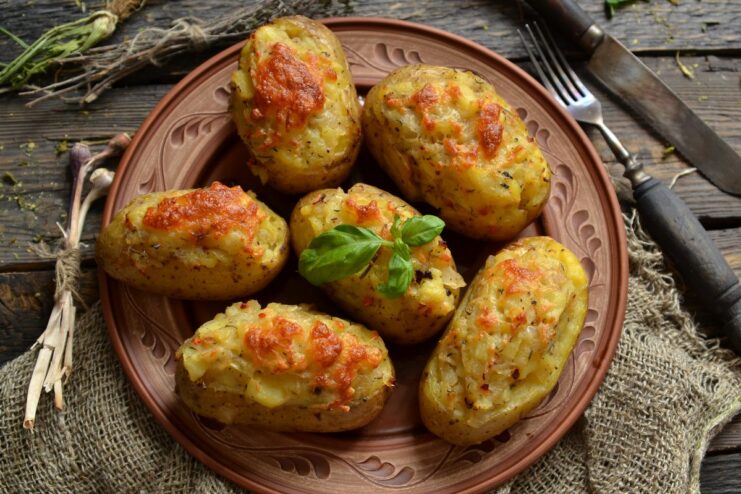 A plate of golden-brown oven-baked stuffed potatoes, ready to be served.