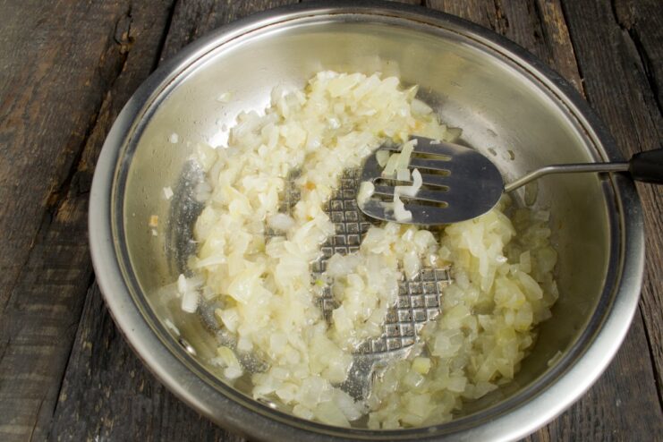 Step 3: Caramelizing onions for the filling Chopped onions being sautéed in a frying pan until golden.