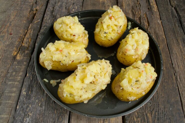 Step 7: Stuffing the potato boats Potato skins being filled with the savory potato and onion mixture.