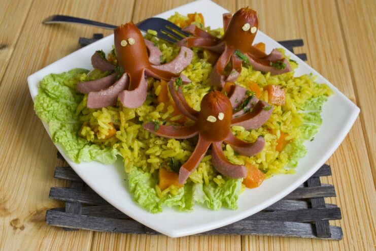 The Final Dish: Plov with Adorable Sausage Octopuses A close-up of the finished plov with sausage octopuses on top of the rice.