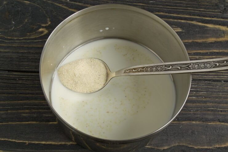 Soaking Semolina in Milk for the Soufflé Base Semolina soaking in a bowl of milk, preparing the base for the fish soufflé.