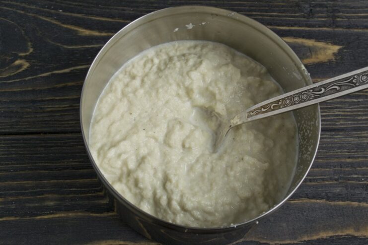 Blending the Fish Soufflé Mixture A food processor blending cooked fish, egg yolks, and soaked semolina into a smooth paste.