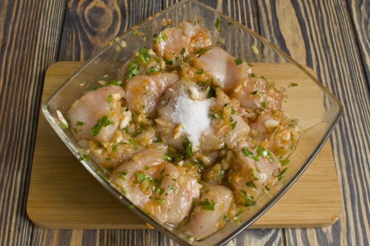 Chicken Shashlik Marinating in the Refrigerator A bowl of marinated chicken covered with plastic wrap, ready for refrigeration.