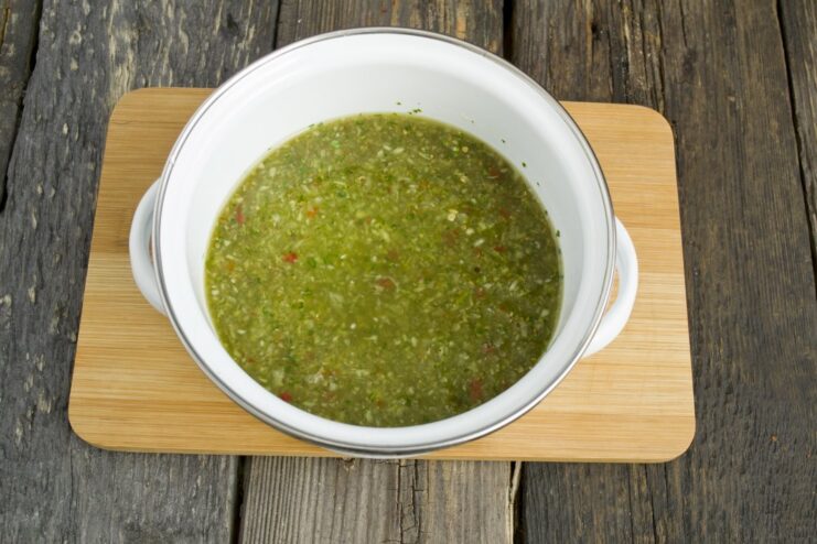 Creating the Flavorful Marinade with Spices A blender bowl with pureed vegetables, paprika, and khmeli-suneli spice mix.