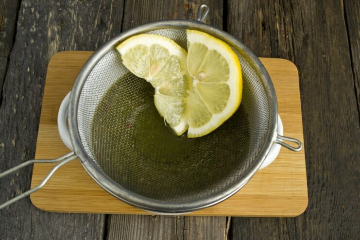 Squeezing Fresh Lemon Juice to Tenderize the Beef Freshly squeezed lemon juice being poured into the shashlik marinade.