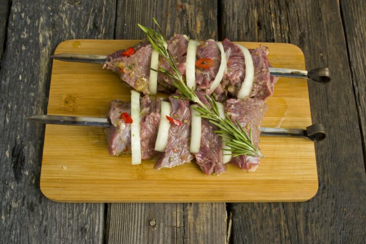 Grilling Beef Shashlik to Perfection Over Hot Coals Beef shashlik skewers grilling over glowing charcoal on a barbecue.