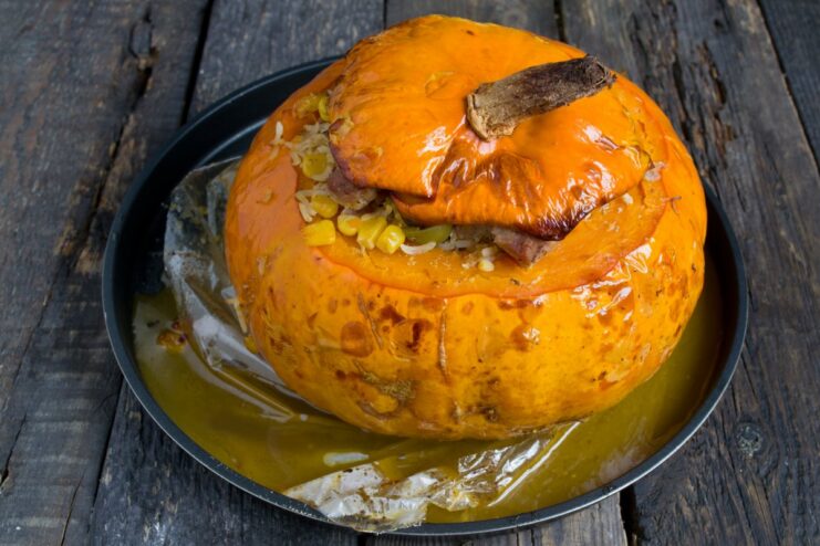 The Finished Dish: A Stunning Stuffed Pumpkin The final dish of Mexican-style pork in a pumpkin, with the top cut open to show the filling.