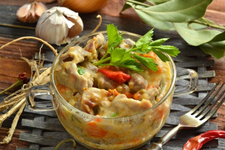 Hearty Chicken Gizzards Stewed in a Creamy Sour Cream Sauce A serving of chicken gizzards stewed in sour cream in a bowl, ready to be eaten.