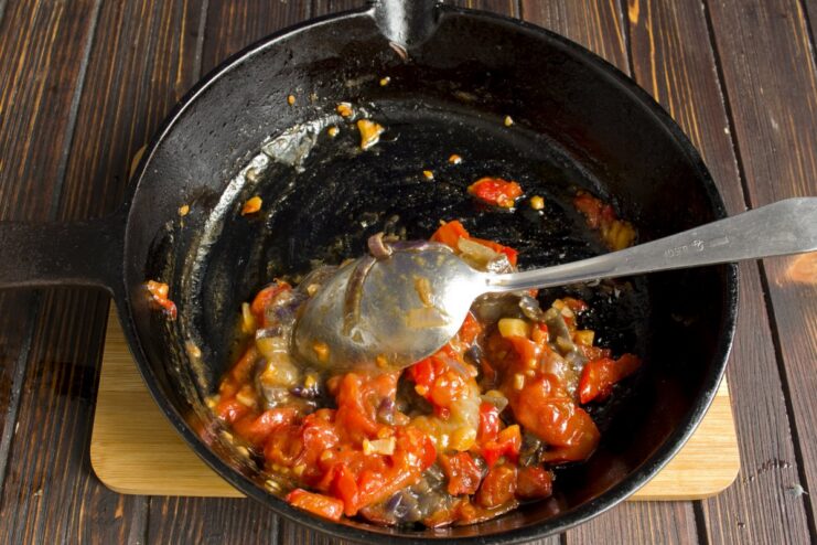 Creating a rich sauce by sautéing vegetables and adding the flavorful onions from baking Sautéing chopped vegetables in a pan to make a sauce for the pork.