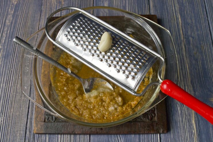 A small bowl with honey, soy sauce, grated onion, and garlic for the chicken marinade.