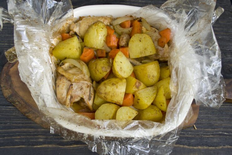 Perfectly Baked Chicken and Potatoes in a Roasting Bag The roasting bag puffed up in the oven, cooking the chicken and potatoes inside.