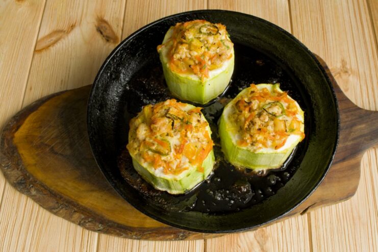 Stuffed Zucchini Baking to Perfection in the Oven A pan of stuffed zucchini baking inside a hot oven.