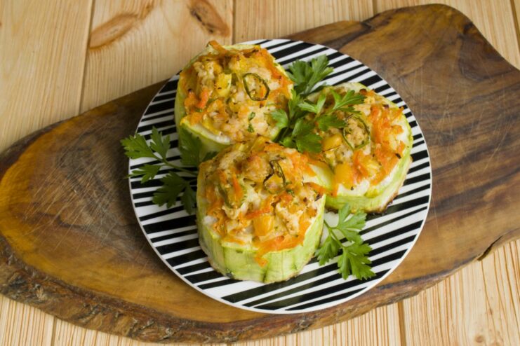 Freshly Baked Stuffed Zucchini with a Creamy Sauce A close-up of the finished oven-baked stuffed zucchini served on a plate.