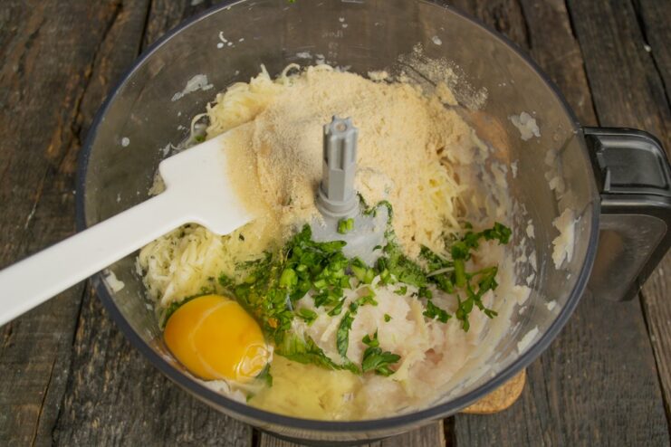 Seasoning the Meatball Mixture with Egg, Pepper, and Paprika An egg, black pepper, and paprika added to the ground chicken mixture before mixing.