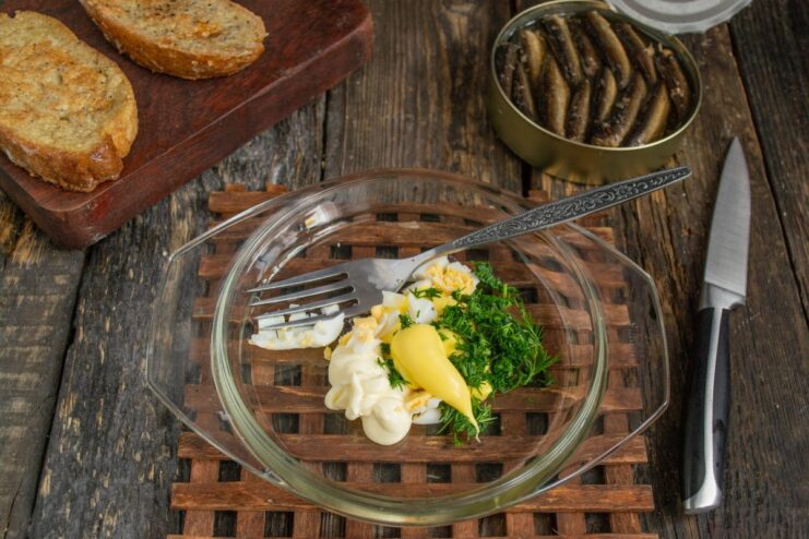 Making the Savory Cheese and Egg Spread Ingredients for the spread: grated egg, cheese, mayo, and dill in a bowl.