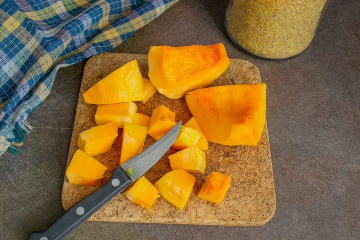 Preparing butternut squash for the recipe Diced butternut squash on a cutting board.