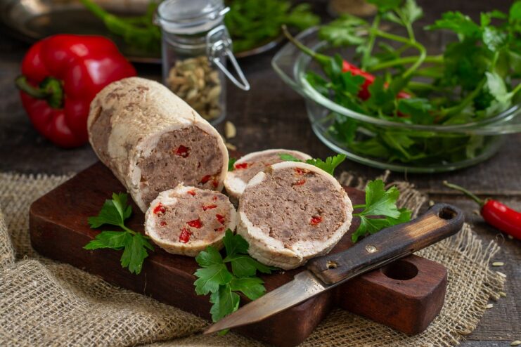 A sliced healthy beef and chicken fillet roll served on a plate.